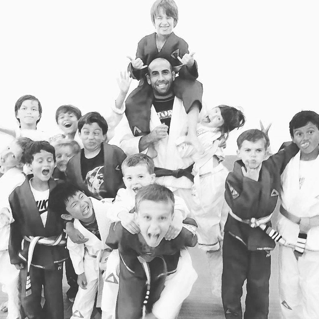 Gracie Gym trainer and his student join together for a group image