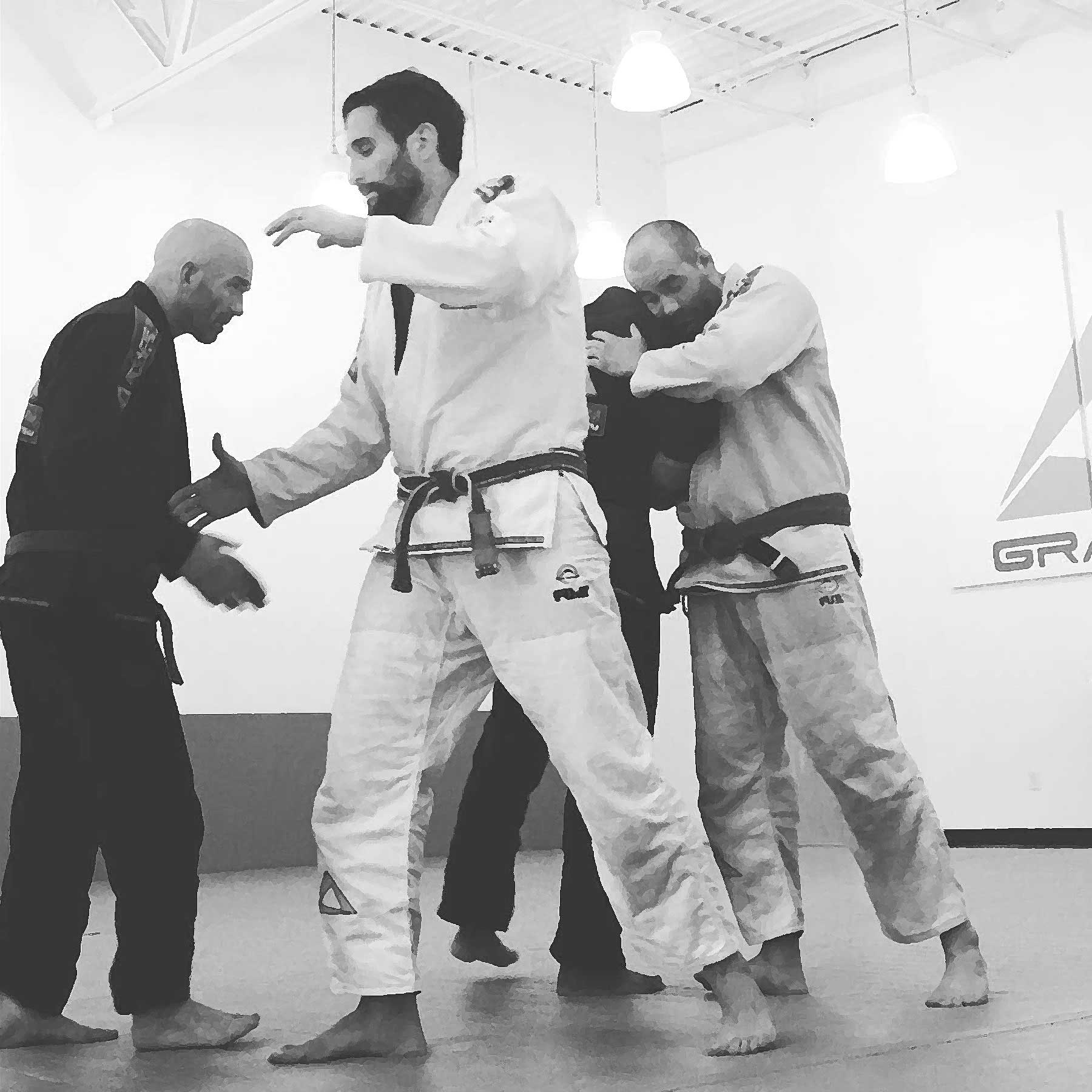 Four men engaged in Jiu-Jitsu practice